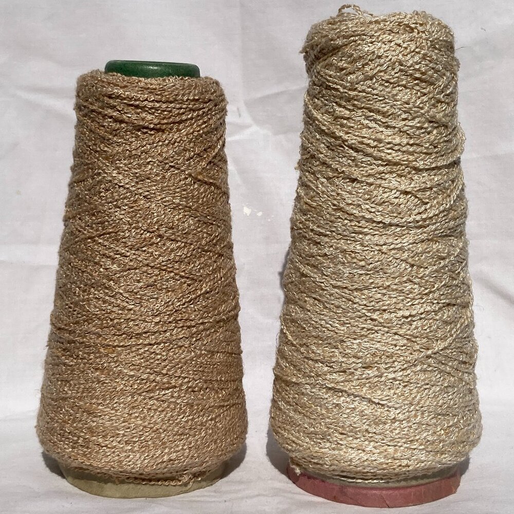two cones of beige rayon boucle yarn